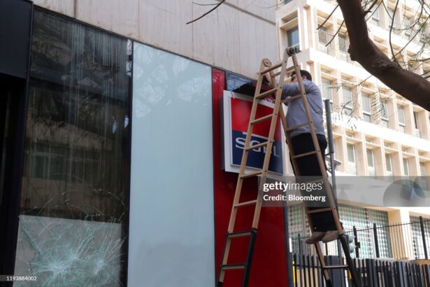 A worker installs a security camera outside a damaged Societe General de Banque au Liban SAL (SGBL) bank branch on Hamra Street in Beirut, Lebanon, on Wednesday, Jan. 15, 2020. Lebanese protesters spilled back into the streets on Tuesday after a brief letup, blocking major highways as they denounced the lack of a functioning government at a time of deepening financial and economic crisis. Photographer: Hasan Shaaban/Bloomberg via Getty Images