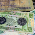 Syrian money background of old coins and banknotes of Livres Liras of different eras, old vintage retro Syria money coin and bills, exchange rate, economy status of Syria, vintage retro ancient money