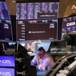 TOPSHOT - A trader works on the floor of the New York Stock Exchange (NYSE) at the opening bell in New York City on March 10, 2025. (Photo by CHARLY TRIBALLEAU / AFP) (Photo by CHARLY TRIBALLEAU/AFP via Getty Images)