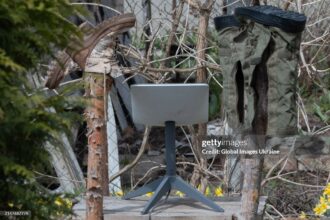 KUPIANSK, UKRAINE - APRIL 7: An antenna of the Starlink satellite-based broadband system stands in a yard next to the wooden posts on which shoes are dried on April 7, 2024 in Kupiansk, Ukraine. On 24 February 2022, Russia invaded Ukraine in an escalation of the Russian-Ukrainian War that started in 2014. After retreating from Kupiansk in September 2022, Russian military repeatedly shelled the city. (Photo by Yan Dobronosov/Global Images Ukraine via Getty Images)